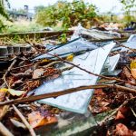 The dangers of fly tipping are highlighted with broken glass.
