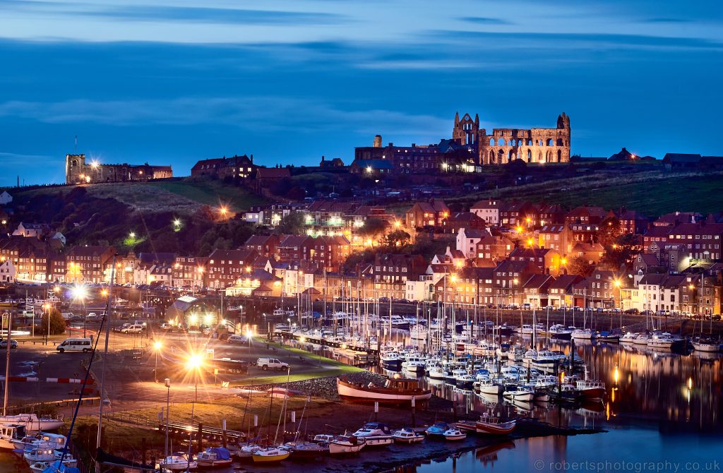 Night view over Whitby fishing port and Marina.